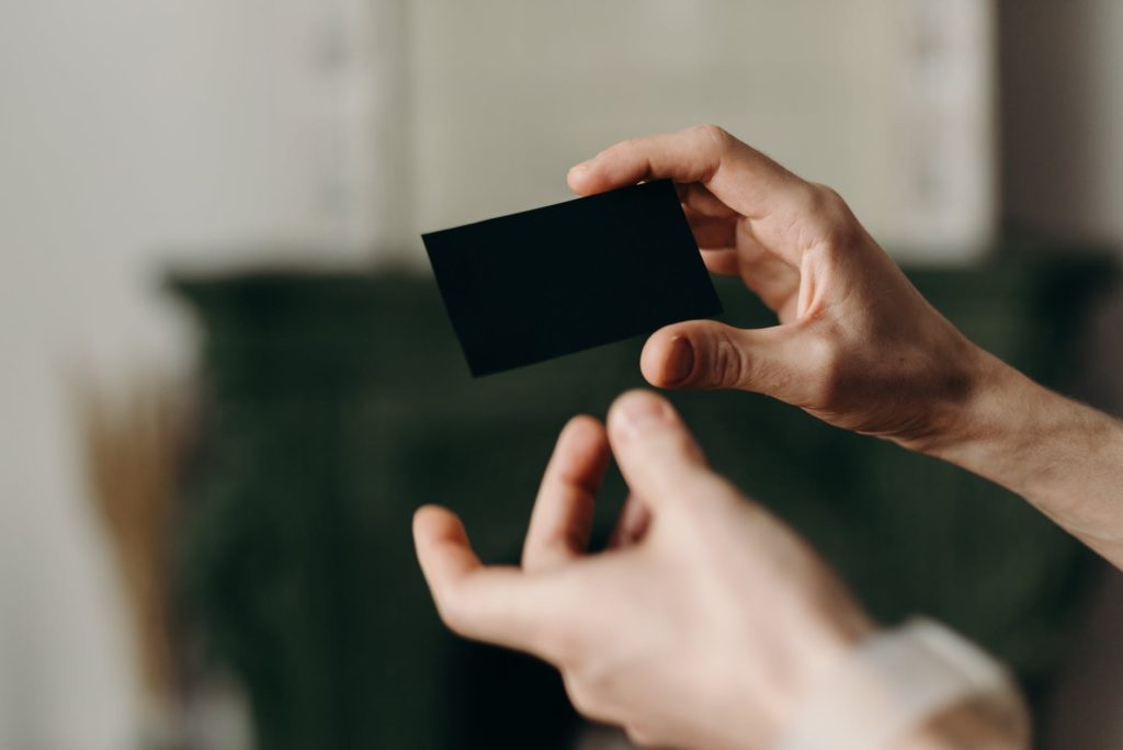 person holding black card